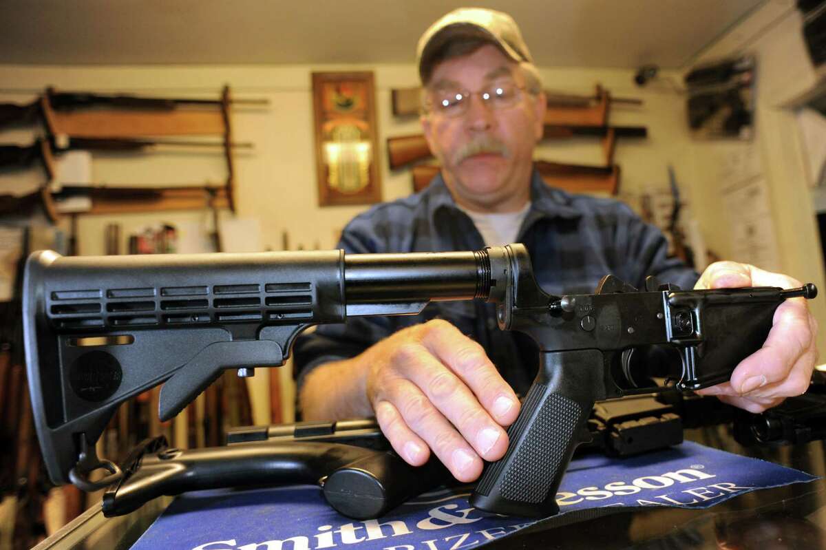 Shop owner Rich Sehlmeyer holds an illegal AR-15 assault-style rifle pistol grip on Saturday, May 25, 2013, at The Gun Shop in Lake Luzerne, N.Y. (Cindy Schultz / Times Union)