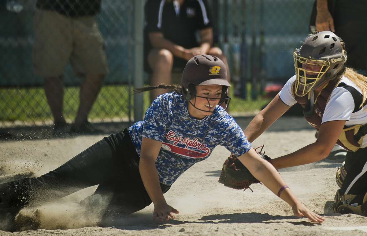 The Lady Explorers' Kaila Fulker manages to reach home plate before being tagged by Line Drive Express' Beth Stroup during their 3-3 tie in the Line Drive Express softball tournament on Saturday in Midland.