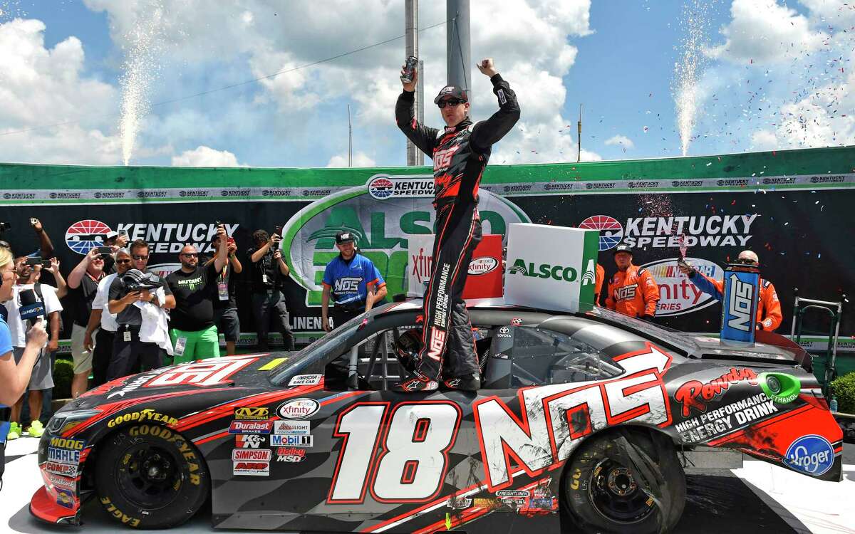 Xfinity Series driver Kyle Busch (18) celebrates in Victory Lane following his victory in the NASCAR Xfinity auto race at Kentucky Speedway, Saturday, July 8, 2017, in Sparta, Ky. (AP Photo/Timothy D. Easley)