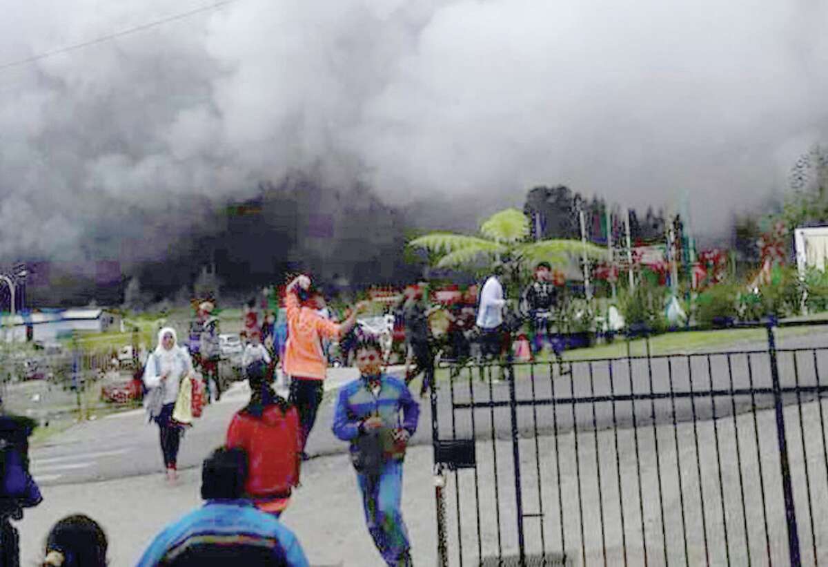 People scrambled to flee an eruption of Java's Sileri Crater.