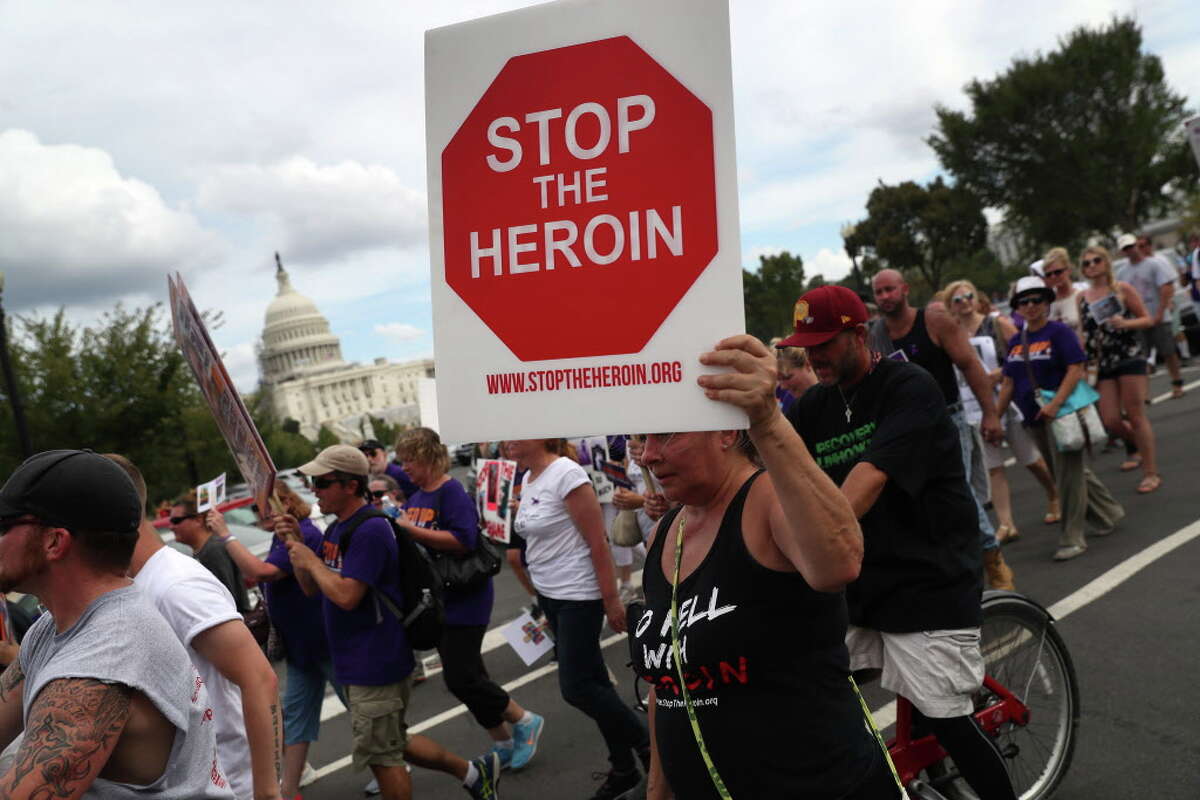 WASHINGTON, DC - SEPTEMBER 18: Activists and family members of loved ones who died in the opioid/heroin epidemic march in a "Fed Up!" rally at Capitol Hill on September 18, 2016 in Washington, DC. Protesters called on legistlators to provide funding for the Comprehensive Addiction and Recovery Act, which Congress passed in July without funding. Some 30,000 Americans die each year due to heroin and painkiller pill addiciton in the United States. (Photo by John Moore/Getty Images) ORG XMIT: 668976487