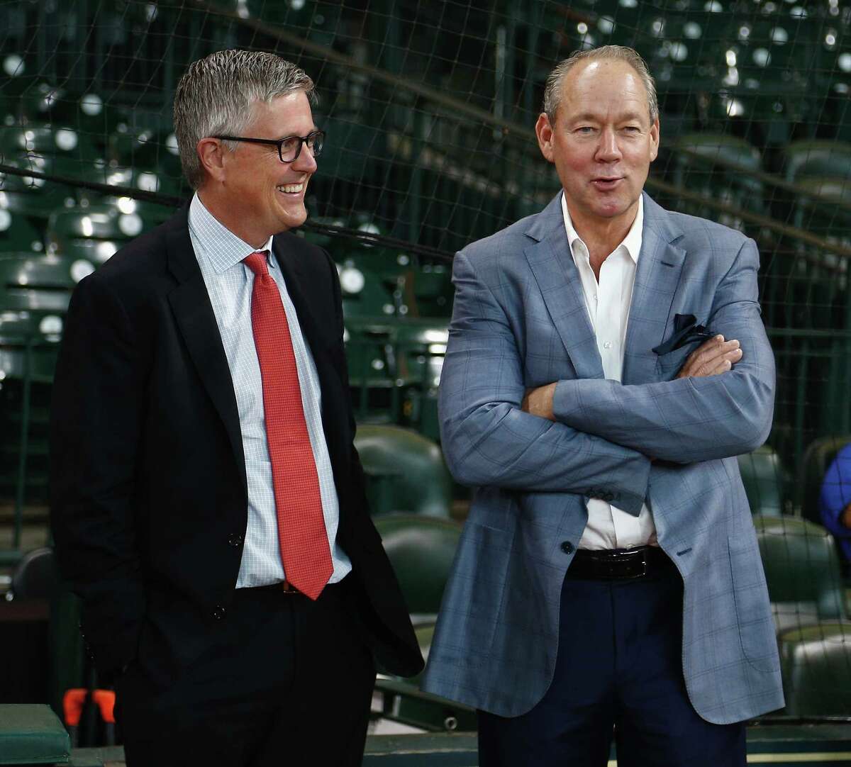 Astros owner Jim Crane, right, and general manager Jeff Luhnow have combined to assemble enough talent to have the best record in the majors and threaten to play in the Fall Classic.