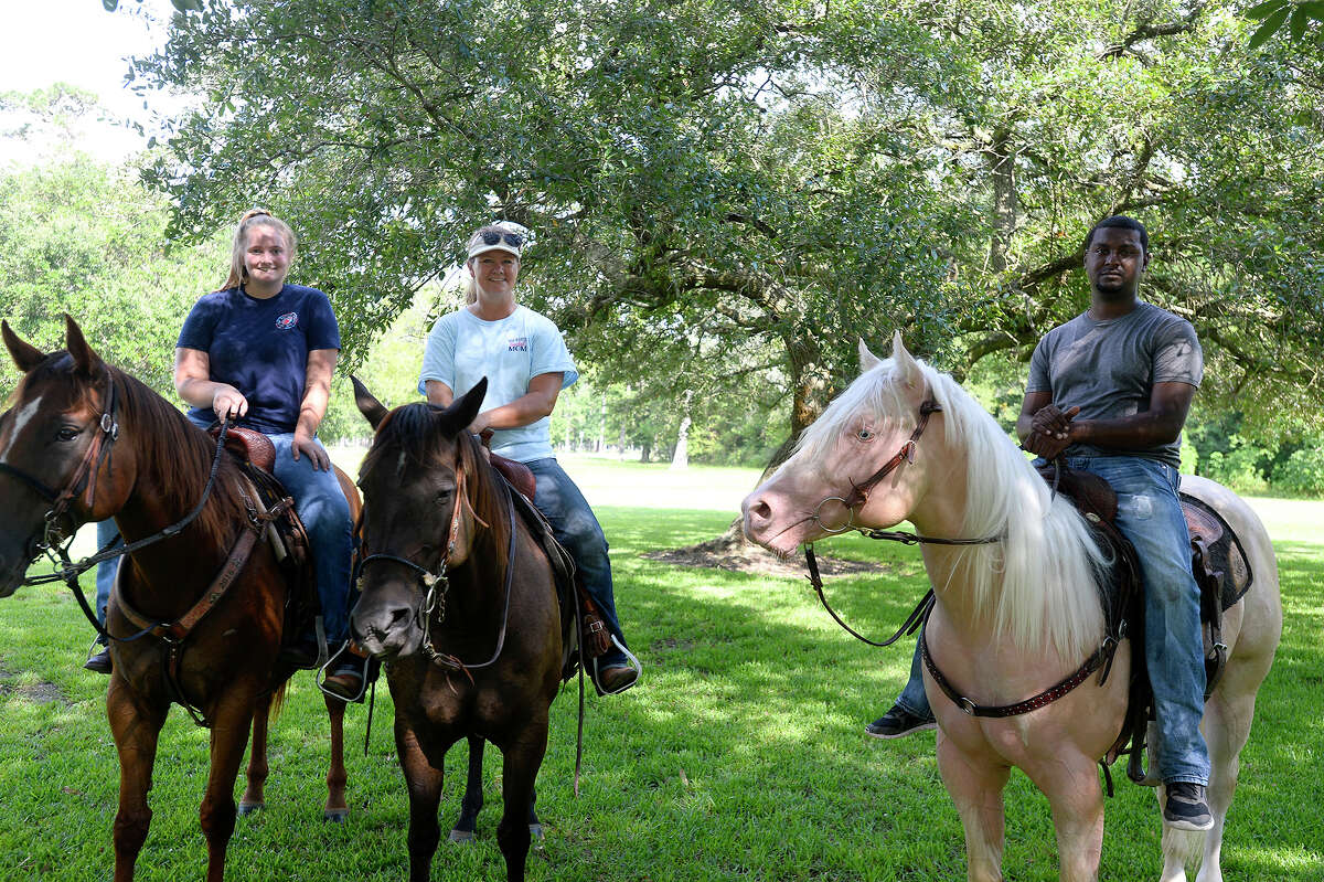 Jenna Turner and Tammie Turner, from Anahuac, and Harold Davis, from Winnie, during the open play day at Tyrrell Park Riding Stables on Saturday. The events are held on the second Saturday of each month to allow riders to ride their horses in the ring. Photo taken Saturday 7/8/17 Ryan Pelham/The Enterprise