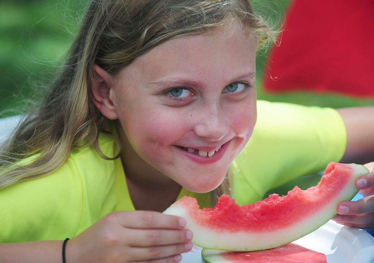 Vivian Knott, 8, enjoys fresh watermelon at The 47th annual RCA River Ramble Saturday, July 8, 2017 at Pinkney Park in Norwalk, Conn.