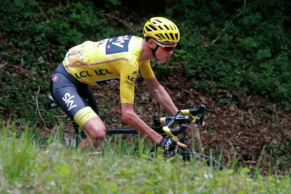 Britain's Chris Froome, wearing the overall leader's yellow jersey, speeds downhill during the ninth stage of the Tour de France cycling race over 181.5 kilometers (112.8 miles) with start in Nantua and finish in Chambery, France, Sunday, July 9, 2017. (AP Photo/Christophe Ena)
