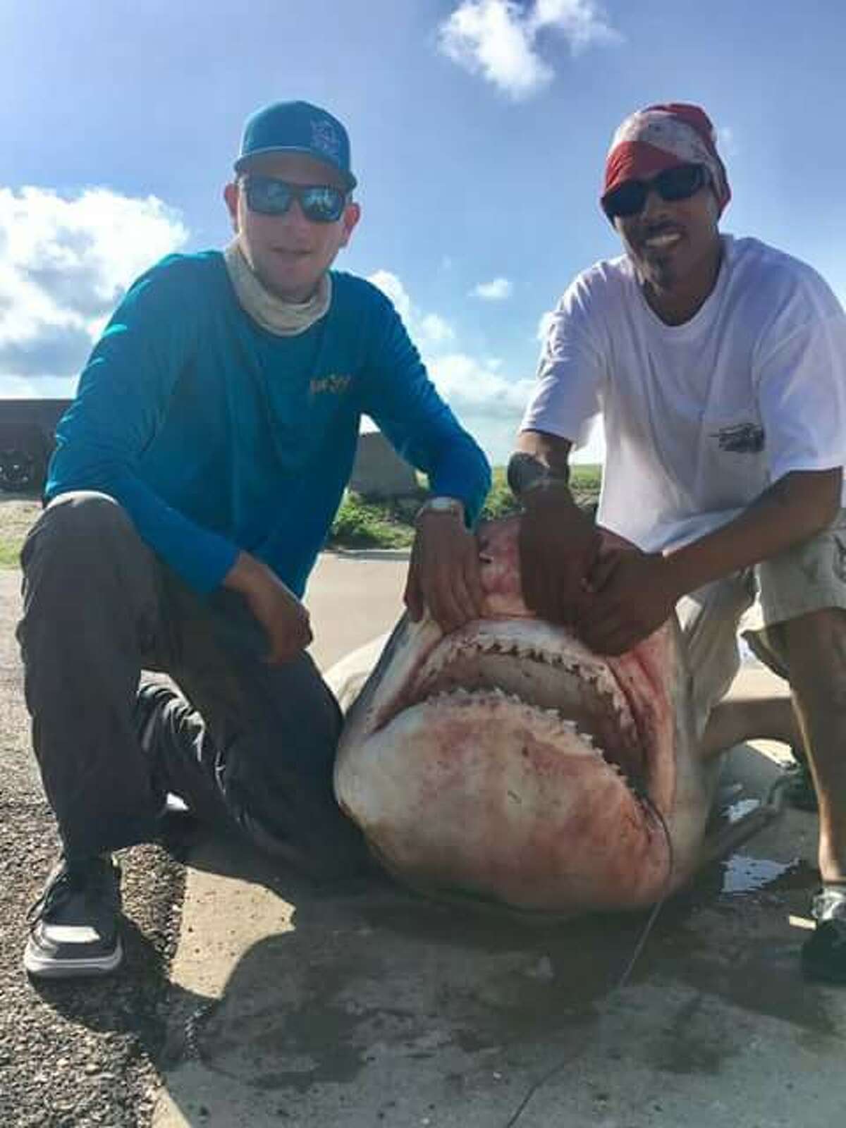 On Sunday, July 2, a massive 964-pound Tiger Shark was reeled in off the shores of Texas City by Sergio Roque (right). The huge catch is 85 percent of the Texas state record.