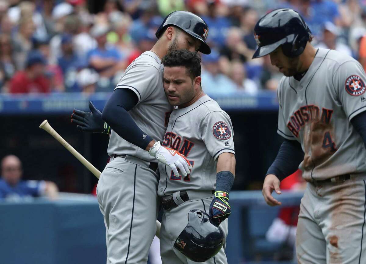 TORONTO, ON - JULY 9: Jose Altuve #27 of the Houston Astros is congratulated by Carlos Correa #1 after hitting a two-run home run in the second inning during MLB game action against the Toronto Blue Jays at Rogers Centre on July 9, 2017 in Toronto, Canada.
