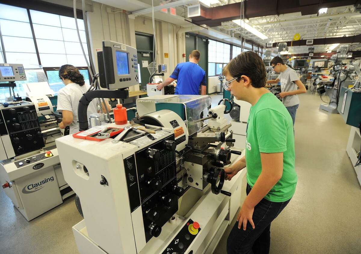 Students in the Young Manufacturers Academy summer program mill aluminum on engine lathes at Emmett O'Brien Technical School in Ansonia, Conn. on Thursday, July 6, 2017.