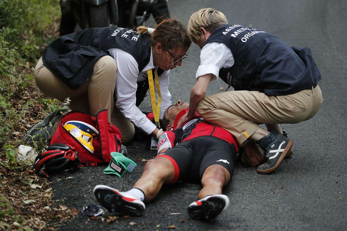 Australia's Richie Porte gets medical assistance after crashing in the descent of the Mont du Chat pass during the ninth stage of the Tour de France cycling race over 181.5 kilometers (112.8 miles) with start in Nantua and finish in Chambery, France, Sunday, July 9, 2017.