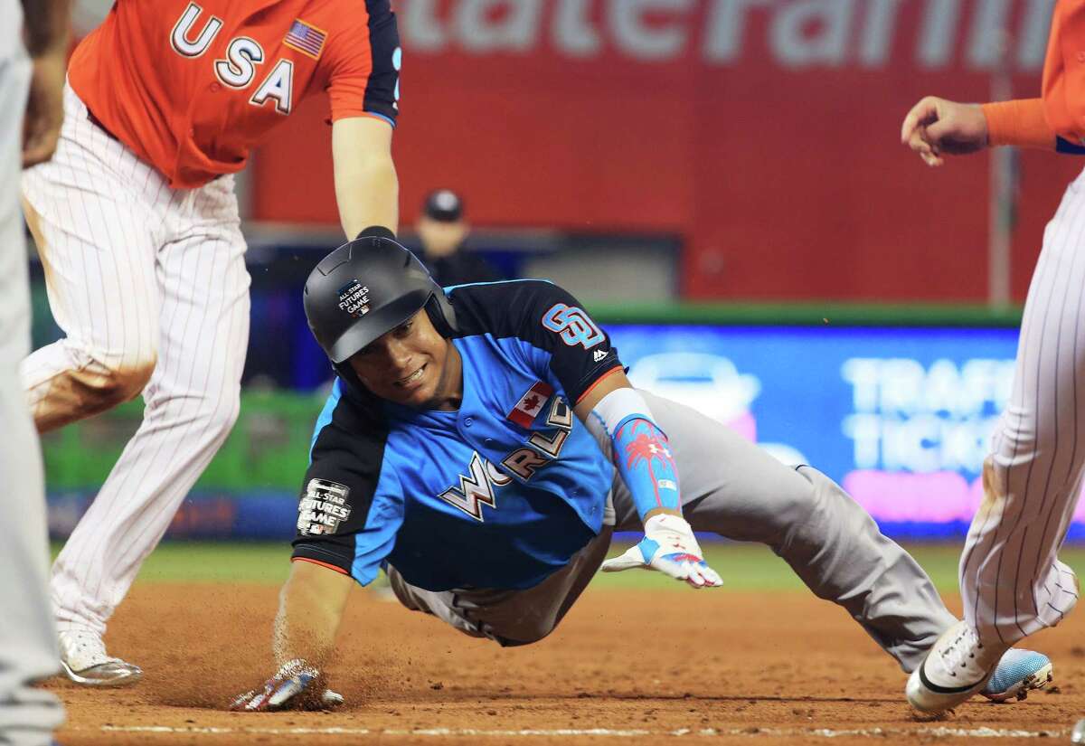 MIAMI, FL - JULY 09: Josh Naylor #14 of the San Diego Padres and the World Team is tagged out by Kyle Tucker #30 of the Houston Astros and the U.S. Team in the fifth inning during the SiriusXM All-Star Futures Game at Marlins Park on July 9, 2017 in Miami, Florida. (Photo by Mike Ehrmann/Getty Images)
