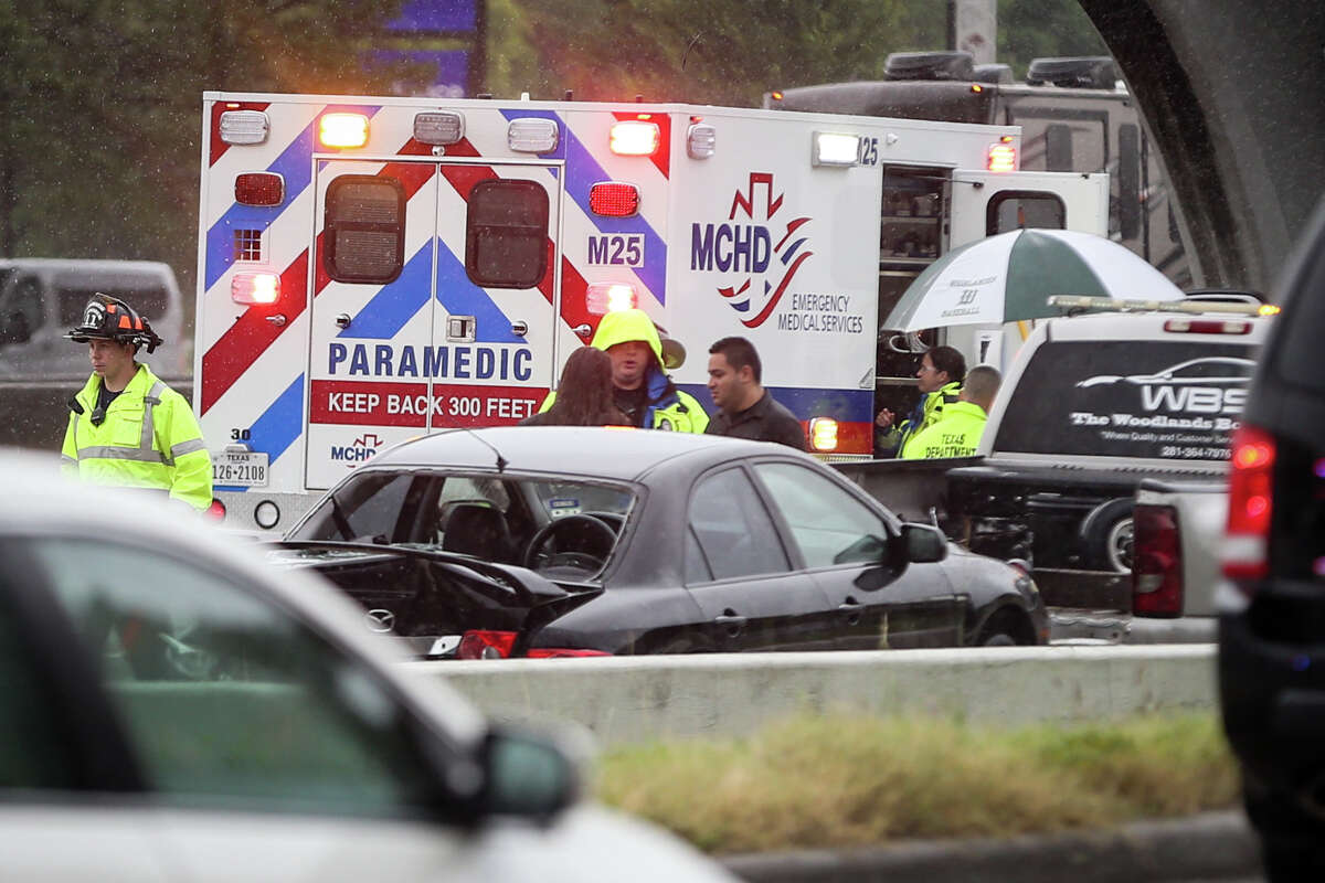 Emergency responders secure the scene of a traffic stop collision involving 3 vehicles, including an Oak Ridge North Police vehicle, on Monday, July 10, 2017, on the southbound exit ramp of Interstate-45 North near Timberloch Place in The Woodlands.