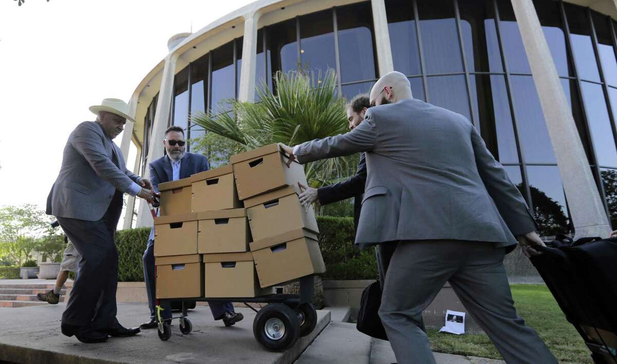 A group moves boxes into the federal courthouse on July 10, 2017, in San Antonio, where a redistricting trial was set to begin.
