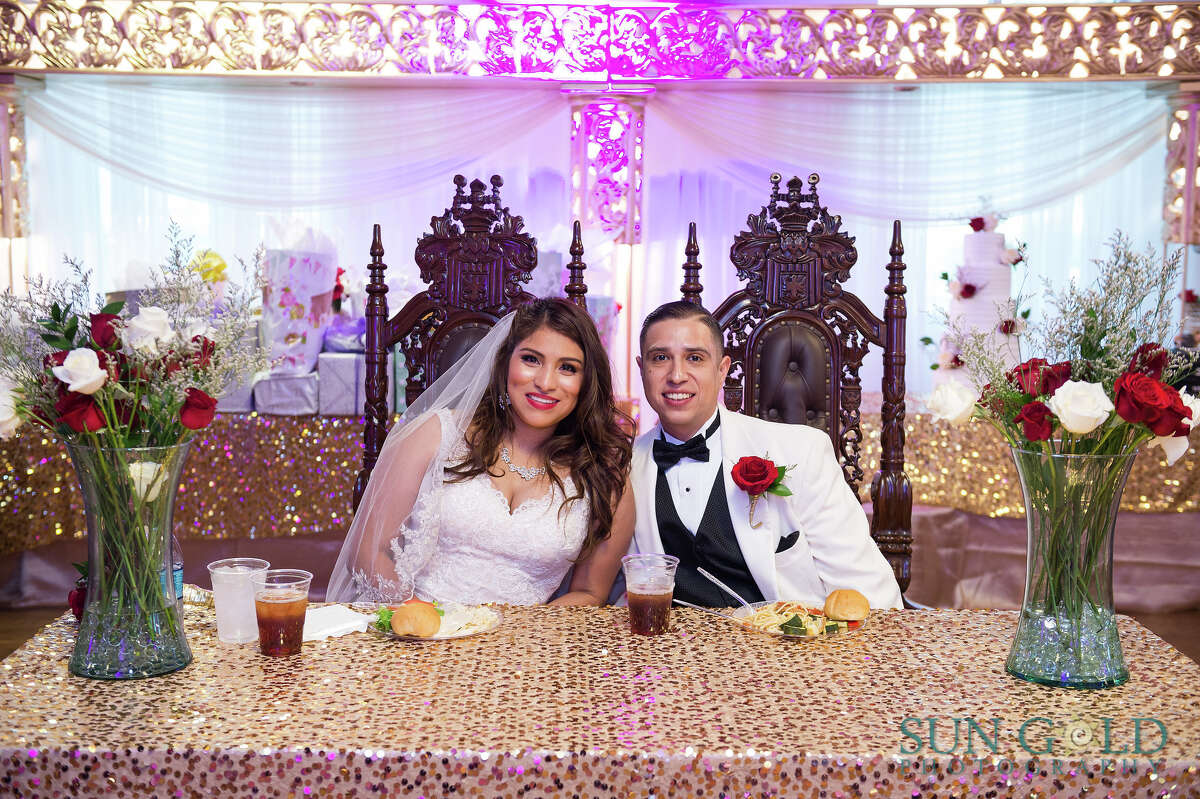 S.A. bride, clearly with her priorities straight, takes wedding photos