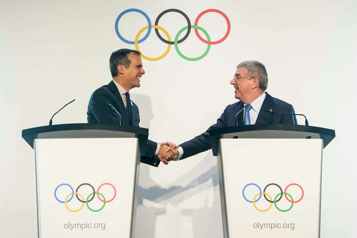 Eric Garcetti, left, Mayor of Los Angeles and International Olympic Committee, IOC, President Thomas Bach from Germany, right, shake hands during a visit of the Los Angeles 2024 Candidate City delegation, at the Olympic Museum, in Lausanne, Switzerland, Monday, July 10, 2017. (Jean-Christophe Bott/Keystone via AP) ORG XMIT: XLAU115