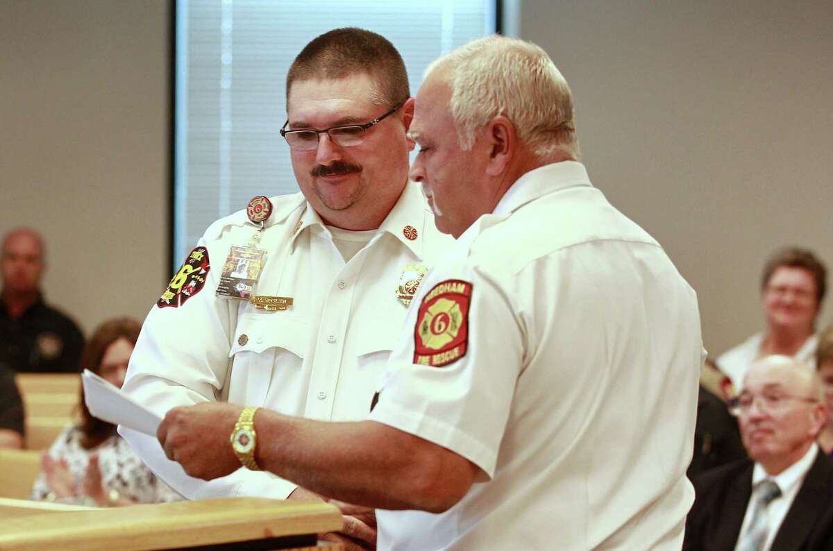Needham Fire Department Chief Kevin Hosler, left, receives a proclamation for his work with the community during Commissioners Court at the Alan B. Sadler Commissioners Court Building, Tuesday, July 11, 2017, in Conroe.