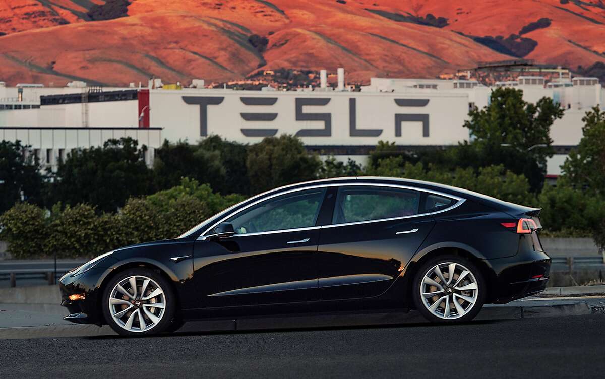 This image provided by Tesla Motors shows the Tesla Model 3 sedan. Electric automaker Tesla has produced its first Model 3 sedan, a highly anticipated car because it carries a relatively low sticker price. On Saturday, July 8, 2017, CEO Elon Musk tweeted pictures of the car, which will cost $35,000 and can travel 215 miles on a single electric charge. A $7,500 federal tax credit for electric vehicles would lower the cost to $27,500. (Courtesy of Tesla Motors via AP)
