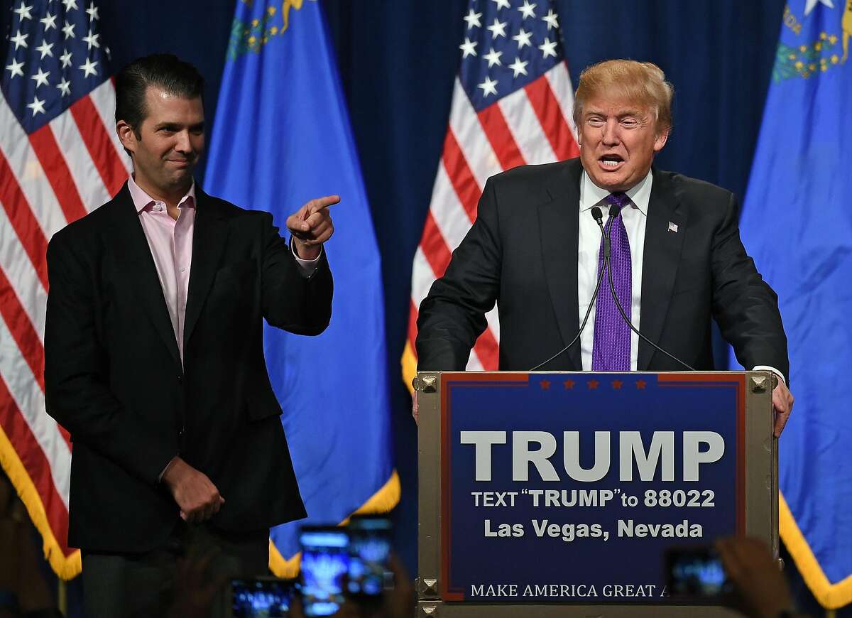 LAS VEGAS, NV - FEBRUARY 23: Donald Trump Jr. (L) looks on as his father, Republican presidential candidate Donald Trump, waves after speaking at a caucus night watch party at the Treasure Island Hotel & Casino on February 23, 2016 in Las Vegas, Nevada. The New York businessman won his third state victory in a row in the "first in the West" caucuses. (Photo by Ethan Miller/Getty Images)