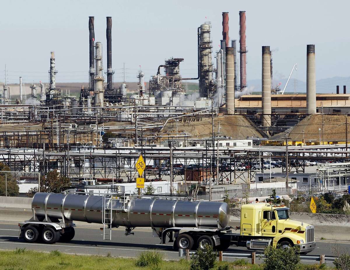 In this March 9, 2010, file photo, a tanker truck passes the Richmond Chevron Refinery in Richmond.