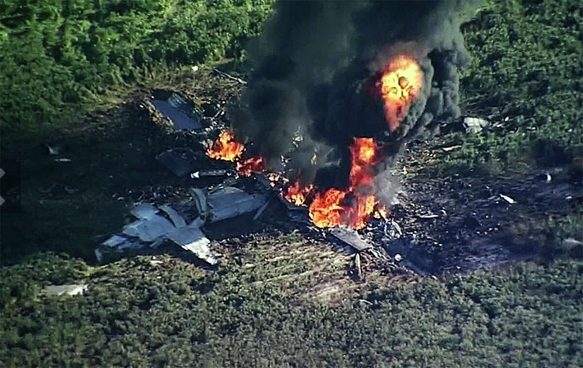 Smoke and flames rise from a KC-130 air tanker Monday in a soybean field in Itta Bena, Miss. The plane was carrying members of an elite Marine special operations unit for training in Arizona when it crashed.