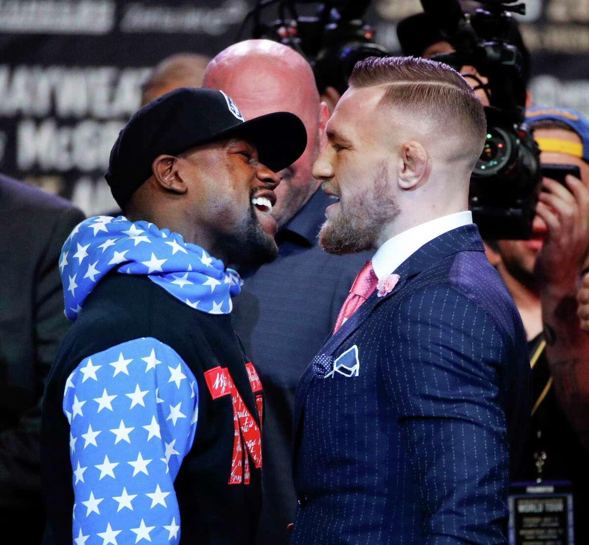 Boxer Floyd Mayweather Jr., left, and mixed martial arts fighter Conor McGregor exchange words during a news conference at Staples Center Tuesday, July 11, 2017, in Los Angeles. The two are scheduled to fight in a boxing match in Las Vegas on Aug. 26. (AP Photo/Jae C. Hong)