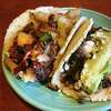 Chorizo and potato taco with bacon and Monterey Jack cheese, left, and a taco al carbon with beef fajitas, green onions, cilantro, avocado and queso fresco, both on handmade corn tortillas, from Las Palapas.