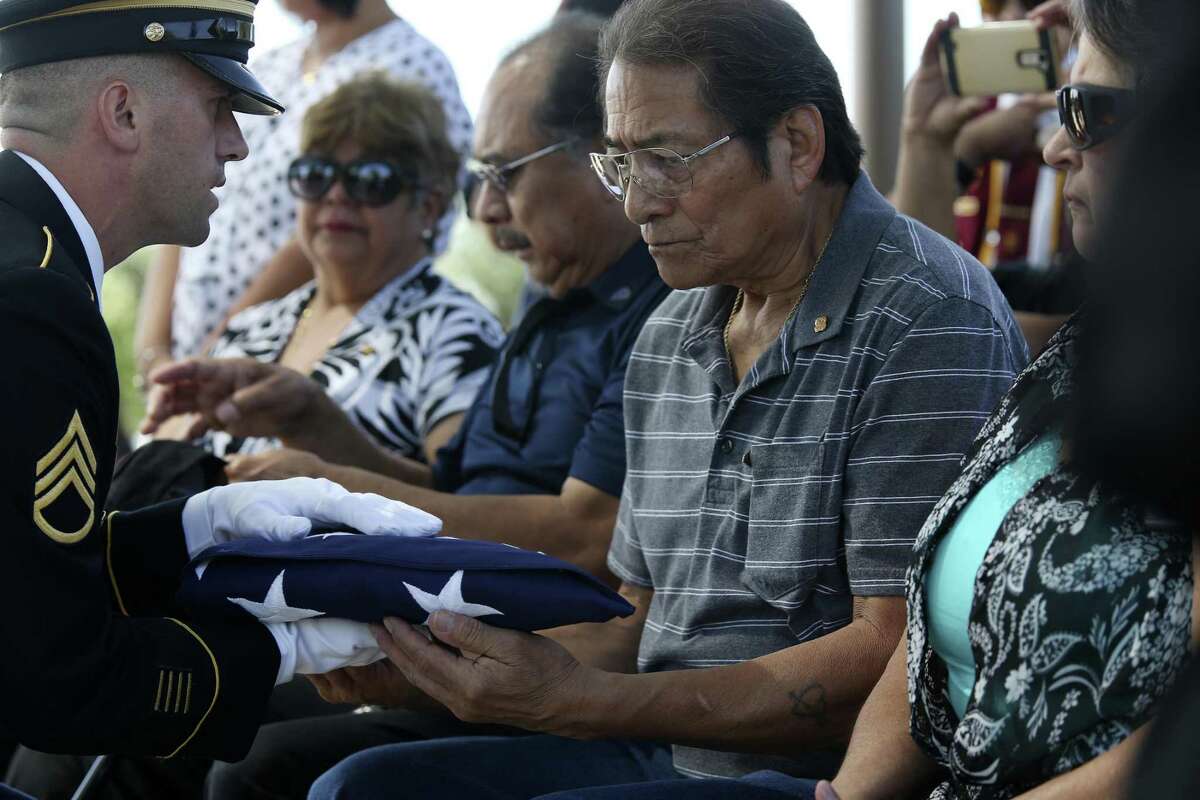 Alex Sandoval, 69, is presented with a flag during the burial ceremony for his father, U.S. Army Cpl. Frank Luna Sandoval, at Fort Sam Houston National Cemetery, Tuesday, July 11, 2017. Sandoval was missing action and presumed dead since the Korean War. Sandoval was 20-years-old when he was take as a prisoner of war and died of malnutrition. Sandoval was reported missing in action on Feb. 13, 1951 and declared dead over two and a half years later. He body was returned to U.S. custody in 1954 and he was buried as an unknown soldier in Hawaii for decades.