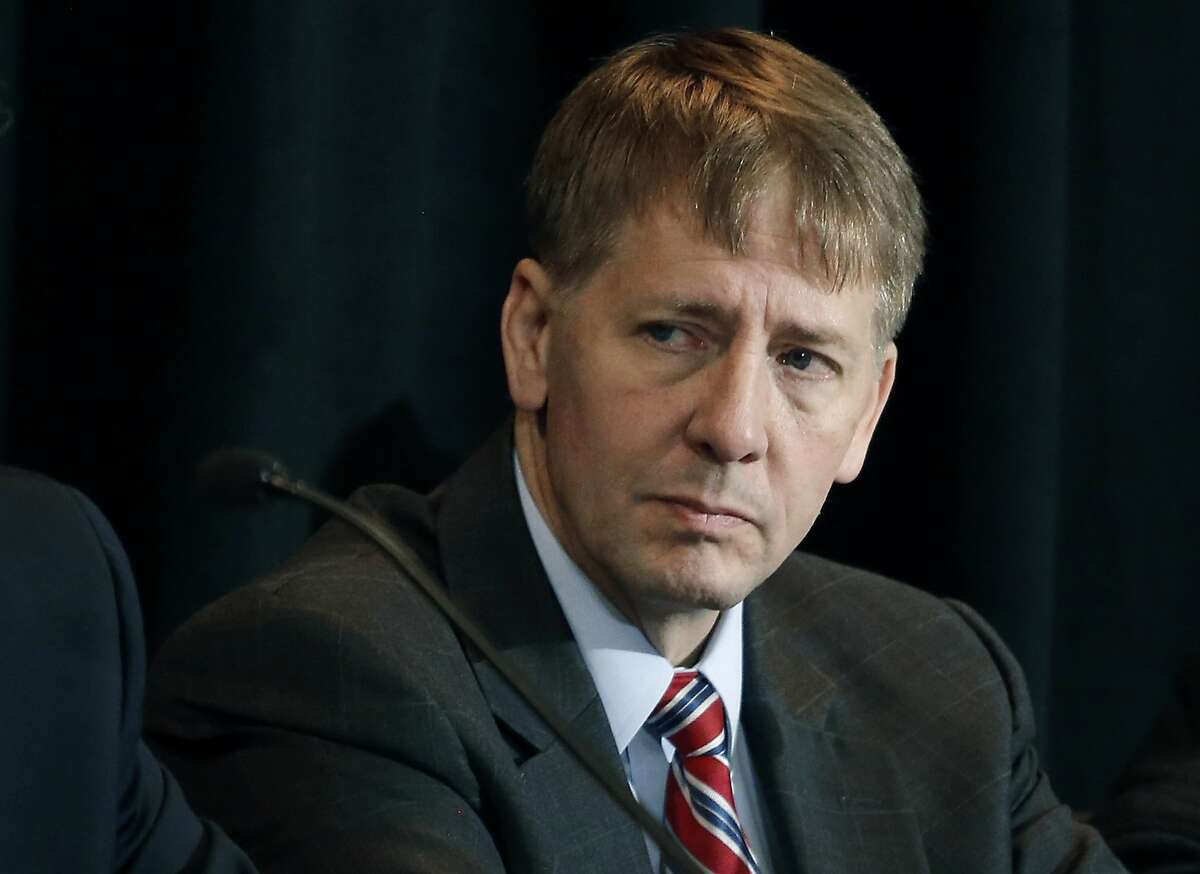 FILE - In this Oct. 7, 2015, file photo, Consumer Financial Protection Bureau Director Richard Cordray listens to a speaker during a hearing in Denver. The CFPB has decided to broadly ban the use of so-called arbitration clauses from financial products. Cordray said mandatory arbitration clauses are a way for banks and other financial companies to �sidestep the legal system.� Consumer advocates have been pushing for years for stricter federal regulation of these types of clauses. But the move is likely to face pushback from the banking industry and the Republican-controlled Congress. (AP Photo/Brennan Linsley, File)