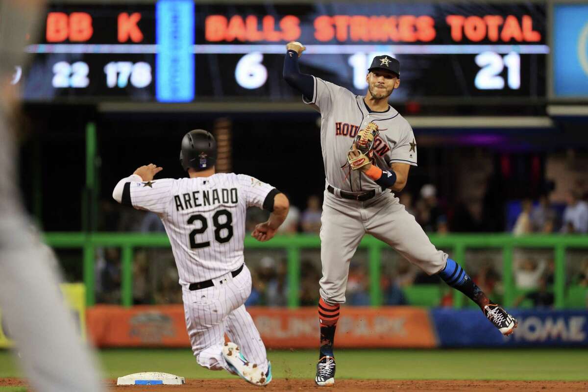 Astros shortstop Carlos Correa helps the AL get out of a second-inning jam by turning a double play started by Jose Altuve.
