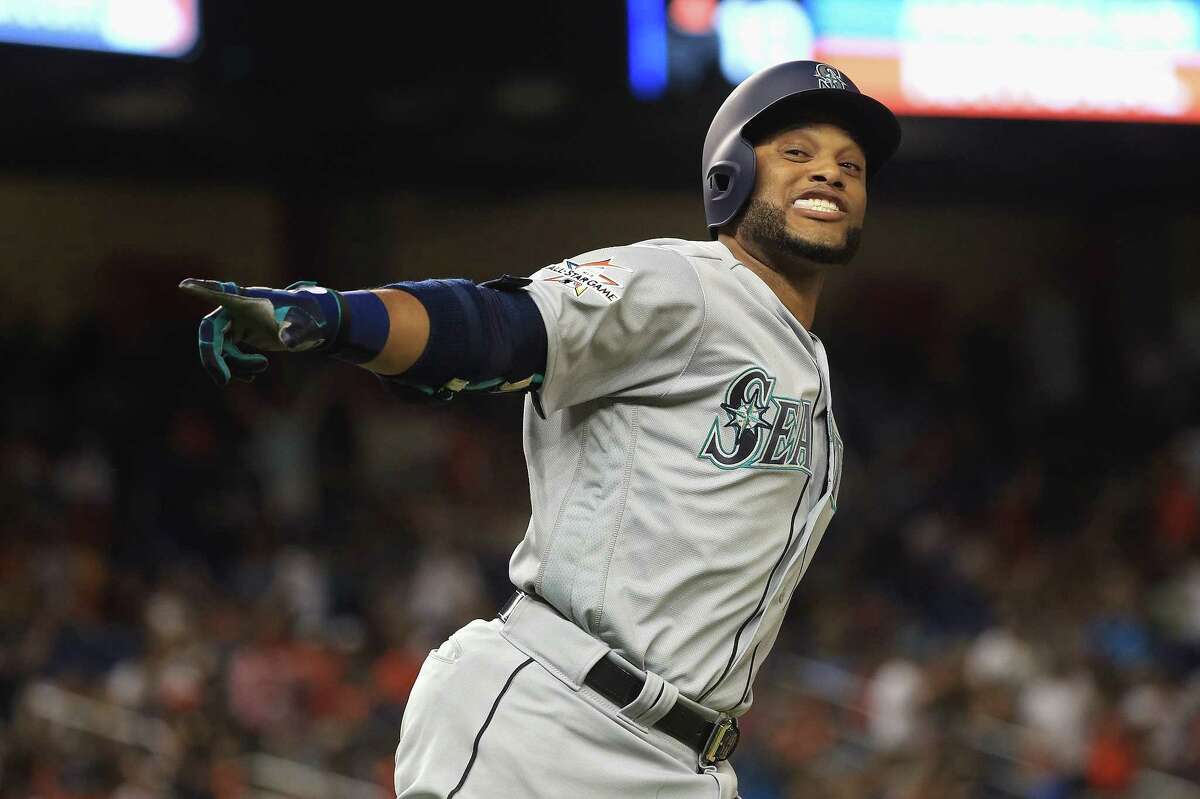 The Mariners' Robinson Cano enjoys his trip around the bases after homering in the 10th inning for the winning margin for the AL.