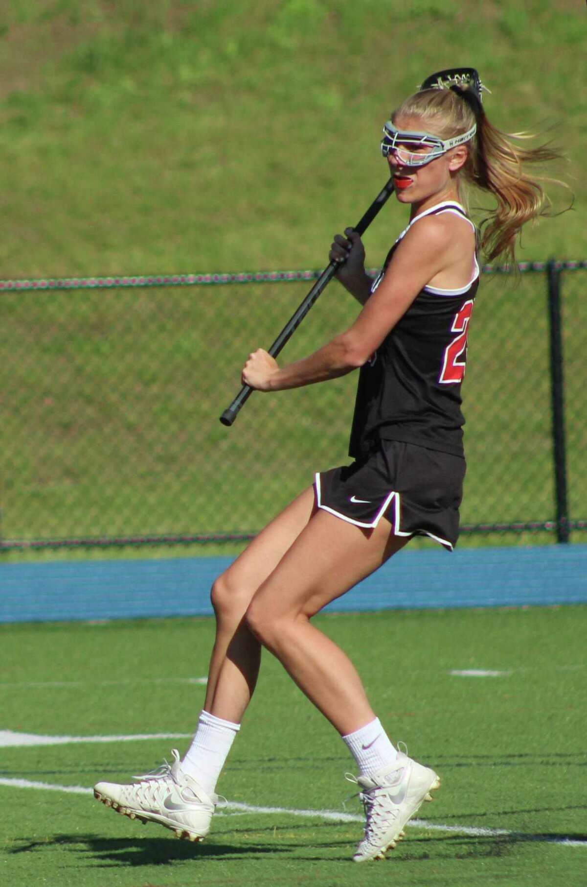 New Canaan's Campbell Armstrong in action during the Class L state girls lacrosse tournament quarterfinal game against Newtown at Newtown High School June 1.