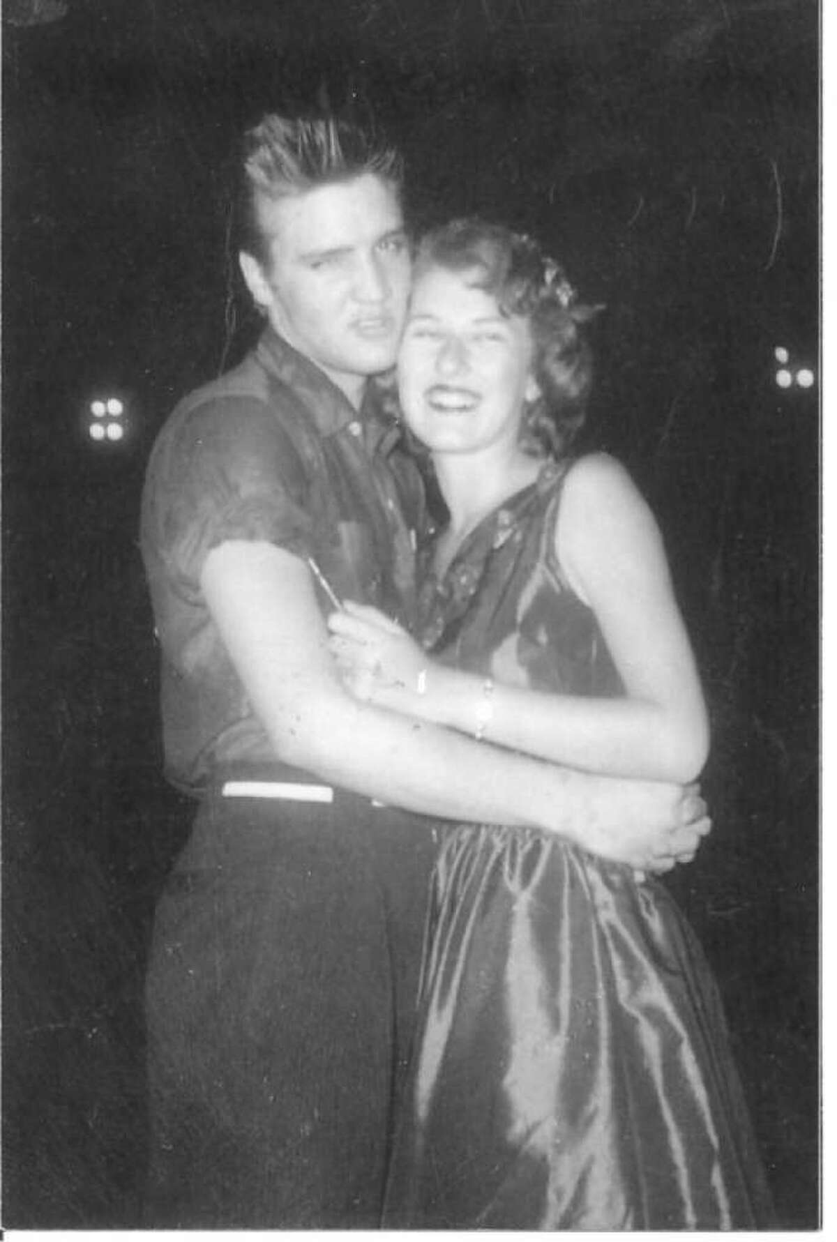 A young Mary McCoy pictured with Elvis Presley when the two perform on The Louisiana Hayride Tour in 1955.