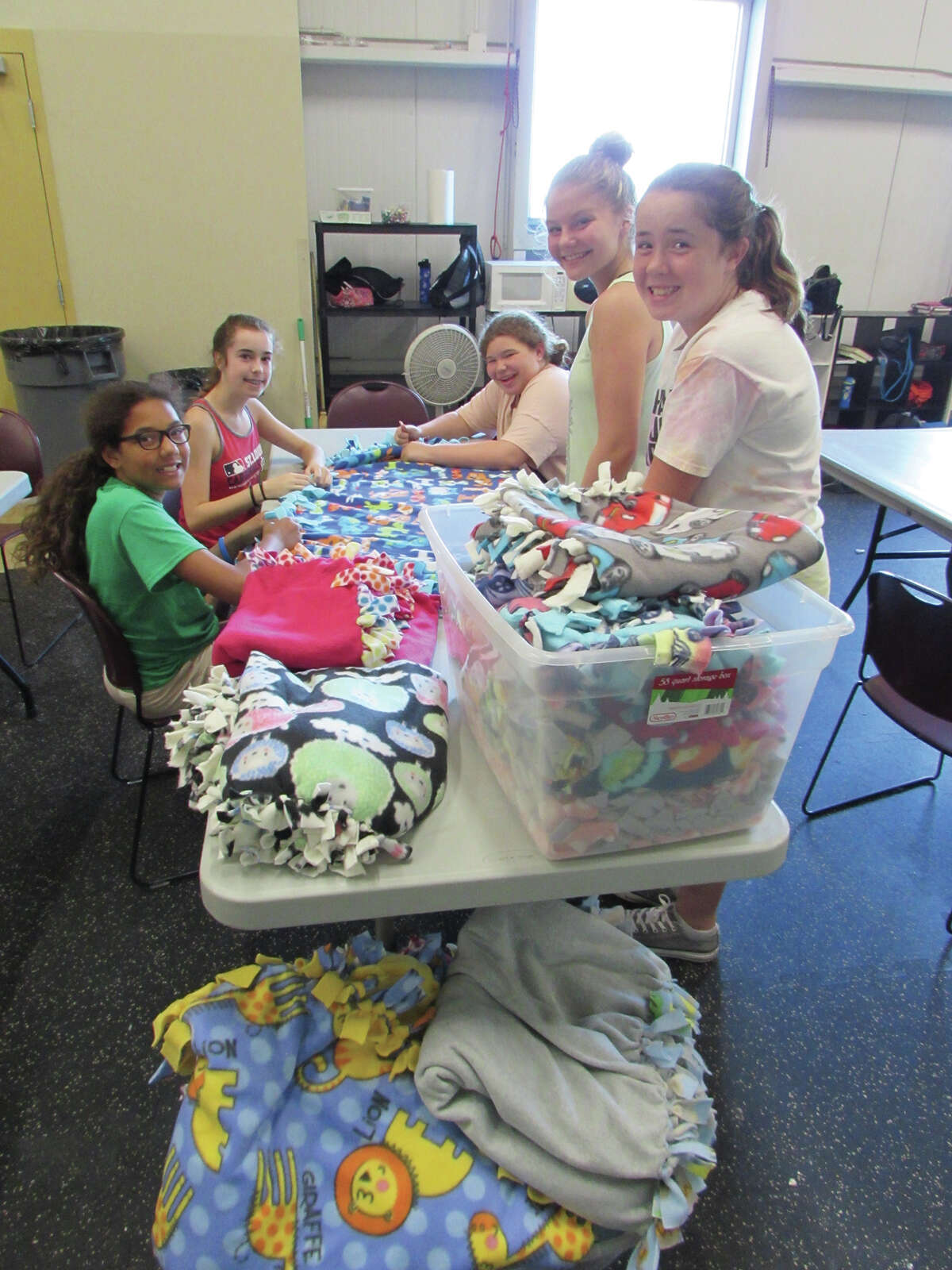 YMCA Teen Adventures Summer campers craft blankets to be donated to Project Linus.