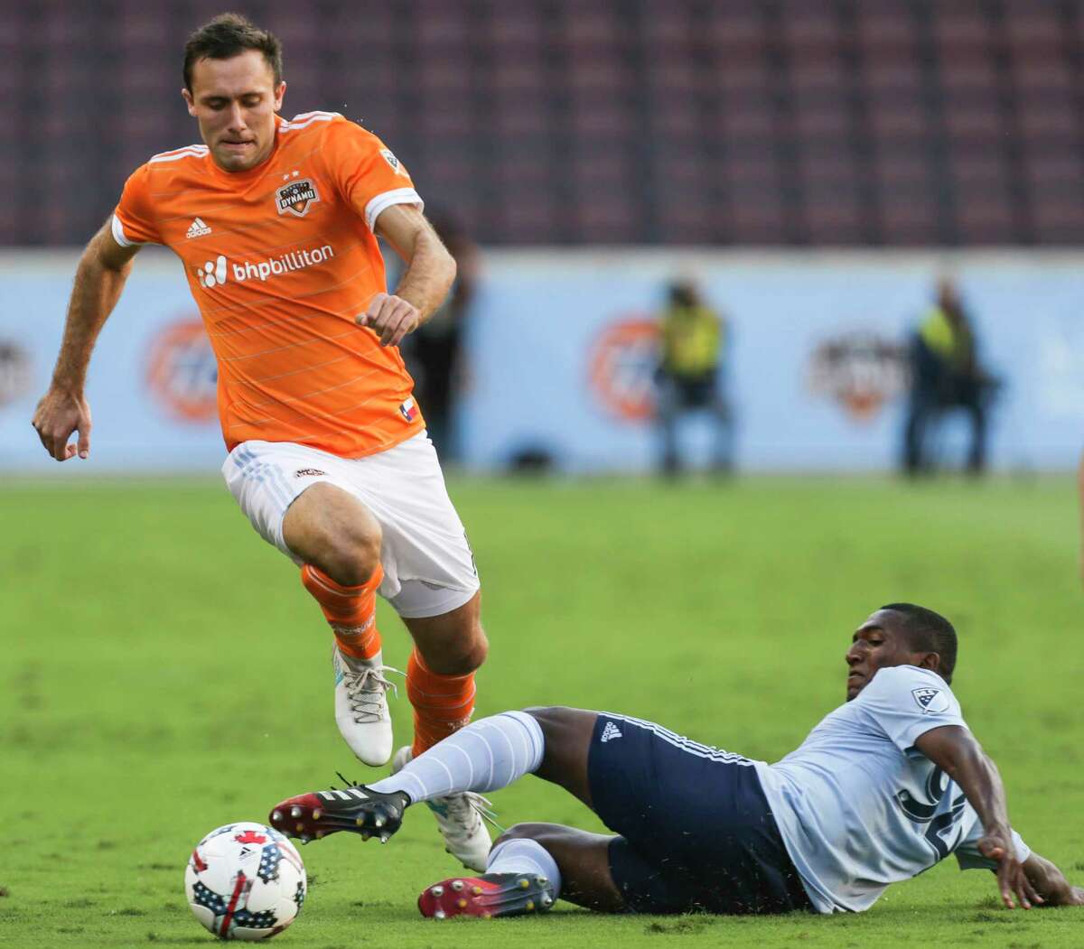 Houston Dynamo forward Andrew Wenger (11) dribbles pass a tackle by Sporting Kansas City midfielder Jimmy Medranda (94) during the first half of the Lamar Hunt U.S. Open Cut Round of 16 game at BBVA Compass Stadium Wednesday, June 28, 2017, in Houston. ( Yi-Chin Lee / Houston Chronicle )