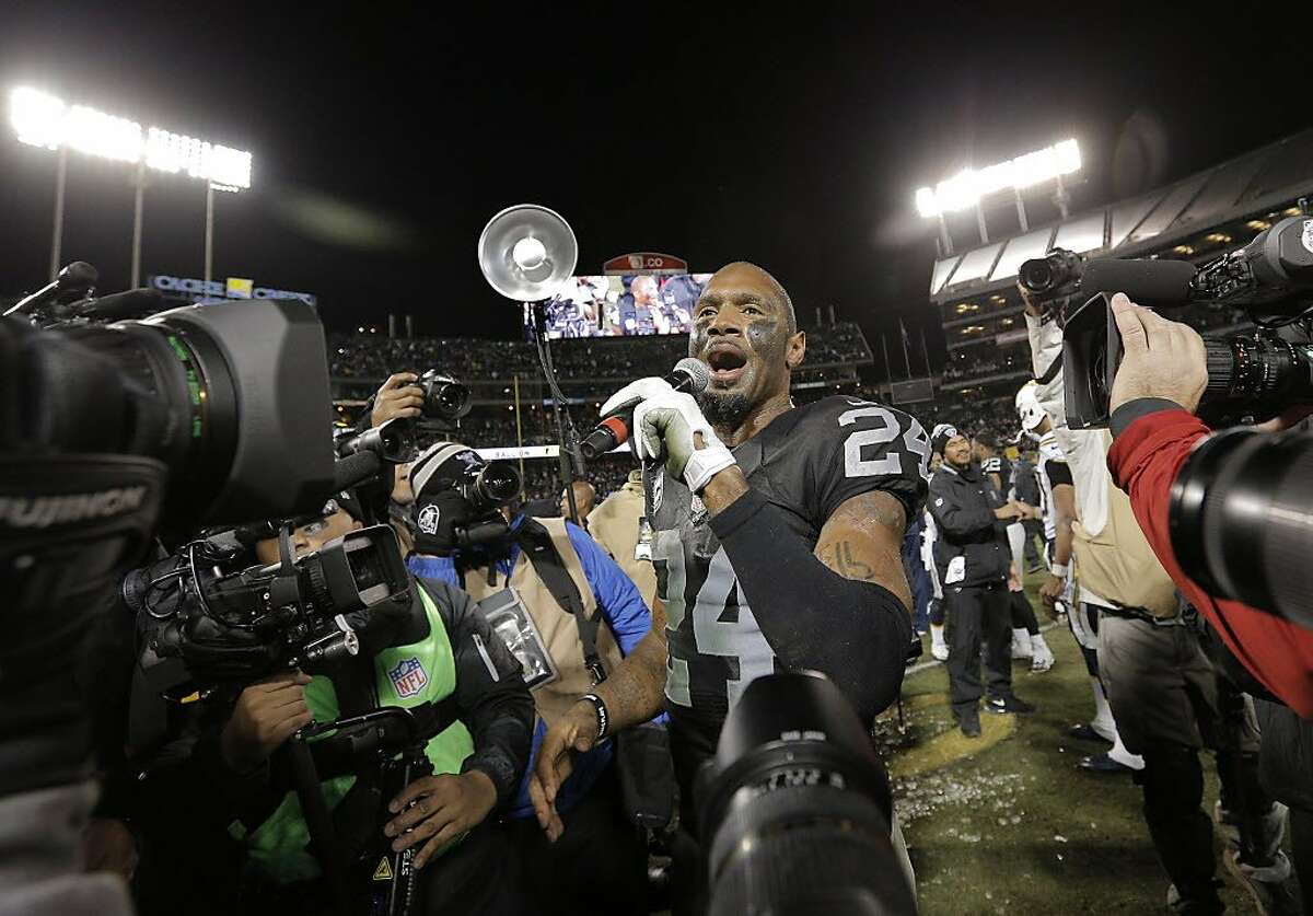 Charles Woodson (24) addresses the crowd as he is honored for his career after the Oakland Raiders defeated the San Diego Chargers at O.Co Coliseum in Oakland, Calif., on Thursday, December 24, 2015.