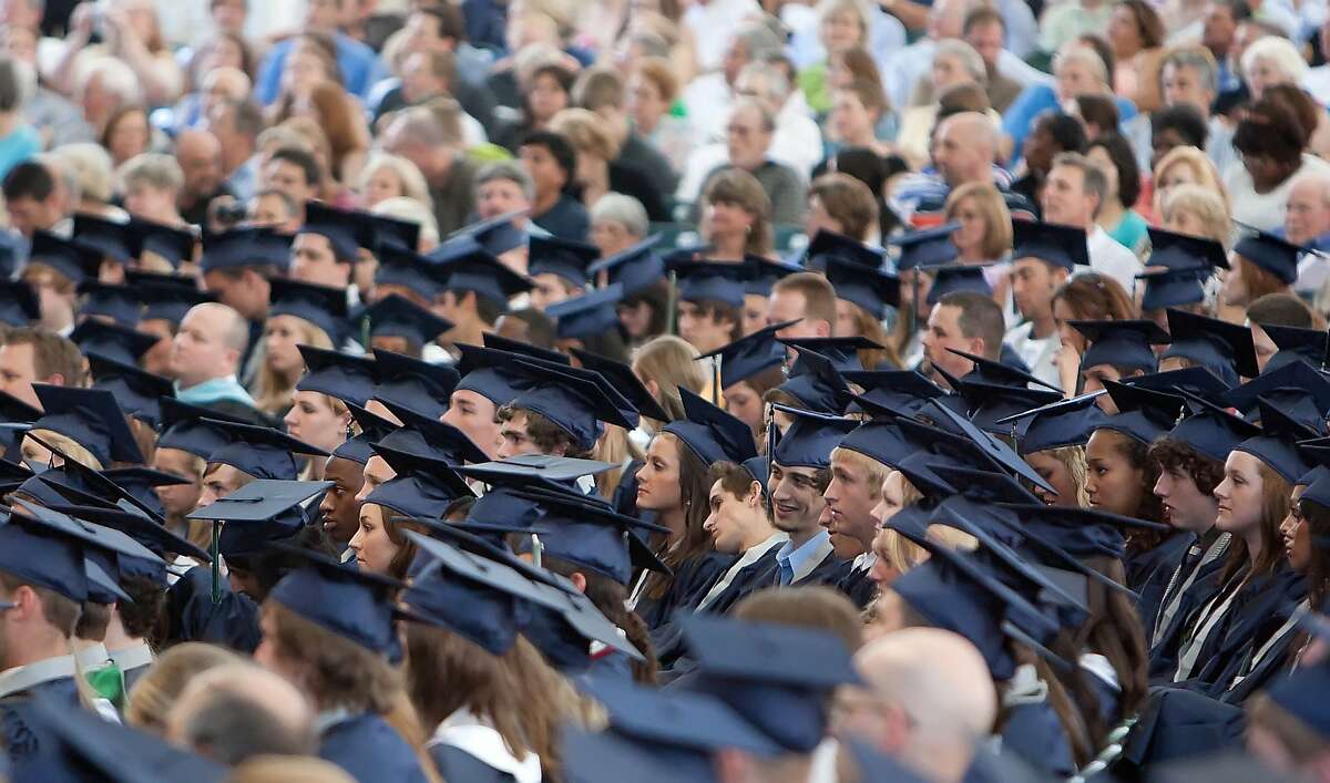 Graduates listen to Principal Mark Murrell during Wednesday's commencement ceremonies for The Woodlands College Park High School at the Cynthia Woods Mitchell Pavilion.