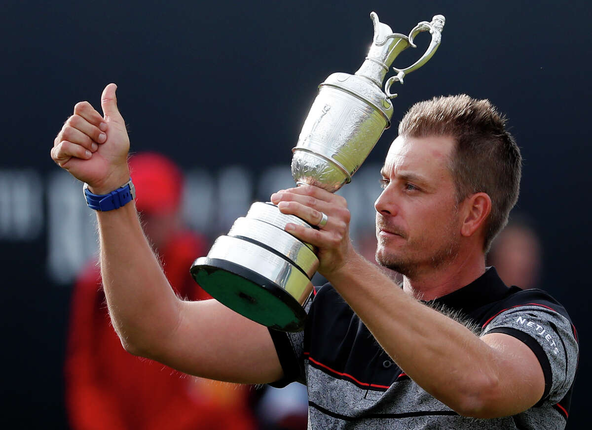 FILE - This is a Sunday, July 17, 2016 file photo of Henrik Stenson of Sweden holds up the trophy tom the crowd after winning the British Open Golf Championships at the Royal Troon Golf Club in Troon, Scotland. Swedish golfer Henrik Stenson golfer is playing the Scottish Open beginning Thursday July 13, 2017 at Dundonald Links, which is a 6-mile (10-kilometer) drive up the west coast from Royal Troon, where he won the British Open last year for his first major title. (AP Photo/Ben Curtis/File)