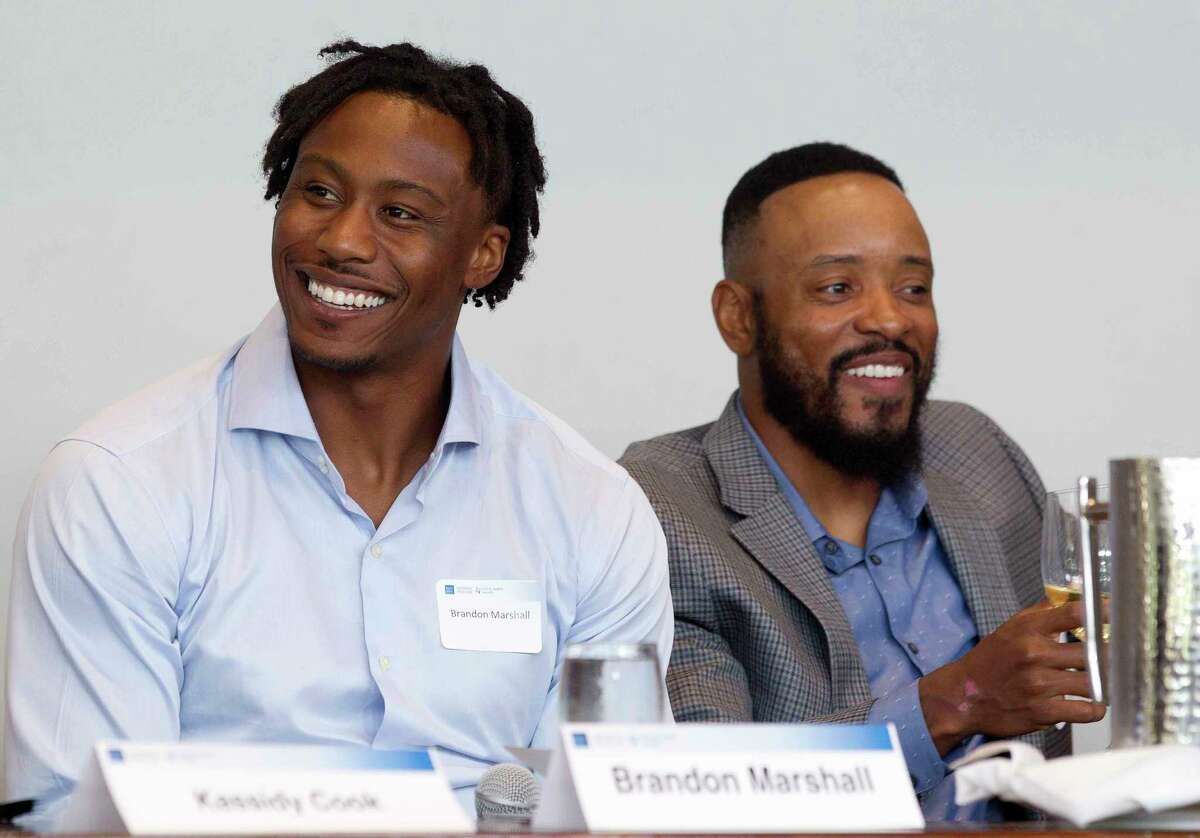 Brandon Marshall, NFL wide receiver with the New York Giants, shares a laugh beside Santana Moss, former NFL wide receiver with the New York Jets and Washington Redskins, during a sports forum titled "Going Pro" at The Woodlands Country Club, Wednesday, July 12, 2017, in The Woodlands. The 10-person panel comprised of athletes, health care providers and others from the sports industry offered advice and answered questions about college recruitment and competing at the professional level.