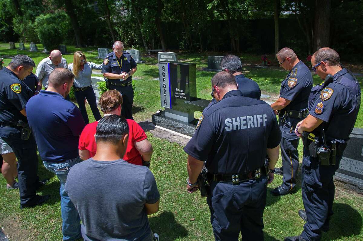 Harris County Sheriff's Office chaplain Lt. Donald Savelle leads a prayer at the new memorial to Harris County Sheriff's Deputy Darren Goforth at Woodlawn Cemetery. Goforth's peers said the monument fit his "down-to-earth" personality. ﻿>>Click to see a timeline of the case.
