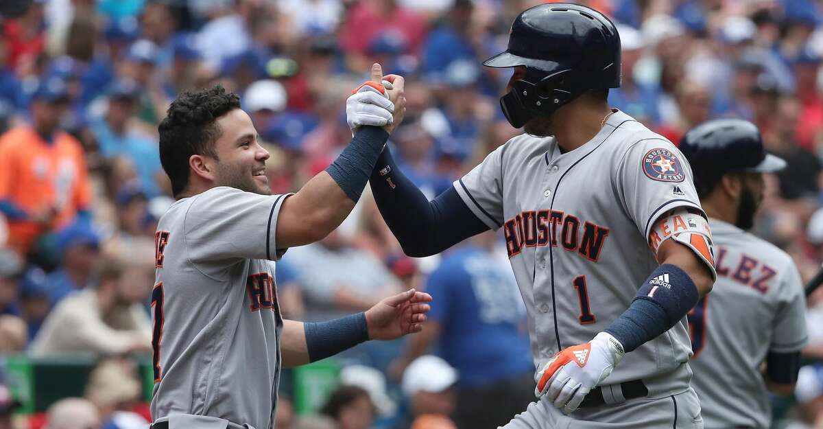 TORONTO, ON - JULY 9: Carlos Correa #1 of the Houston Astros is congratulated by Jose Altuve #27 after hitting a solo home run in the second inning during MLB game action against the Toronto Blue Jays at Rogers Centre on July 9, 2017 in Toronto, Canada. (Photo by Tom Szczerbowski/Getty Images)