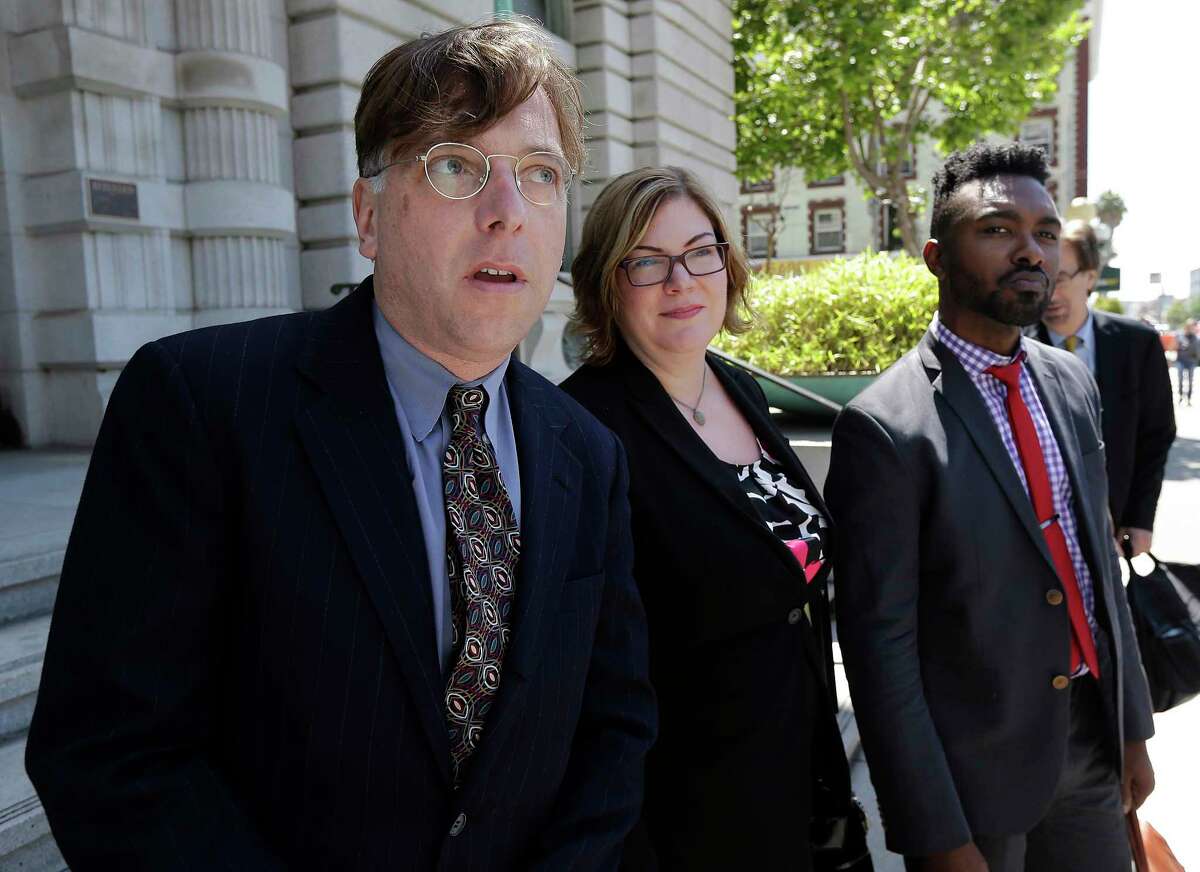 Attorney Andrew Dhuey, from left, representing photographerÂ DavidÂ Slater, attorney Angela Dunning, representing Blurb, a San Francisco-based self-publishing company, and Trevor Cooper, Legal Counsel at Blurb, speak to reporters outside of the 9th U.S. Circuit Court of Appeals in San Francisco, Wednesday, July 12, 2017. Attorneys for Slater, a wildlife photographer whose camera was used by a monkey to snap selfies, asked a federal appeals court to end a lawsuit seeking to give the animal rights to the photos. People for the Ethical Treatment of Animals sought a court order in 2015 allowing it to administer all proceeds from the photos to benefit the monkey. (AP Photo/Jeff Chiu)
