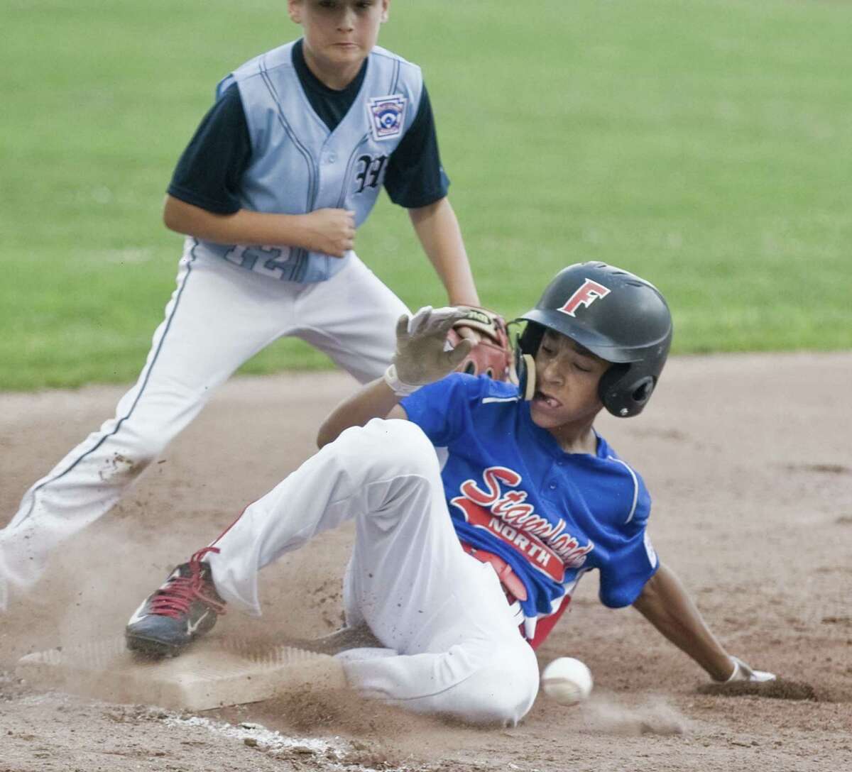 Stamford North's Antonio Belgrove slides into third during the Little League playoffs against Wilton, at Scalzi Park in Stamford. Wednesday, July 12, 2017