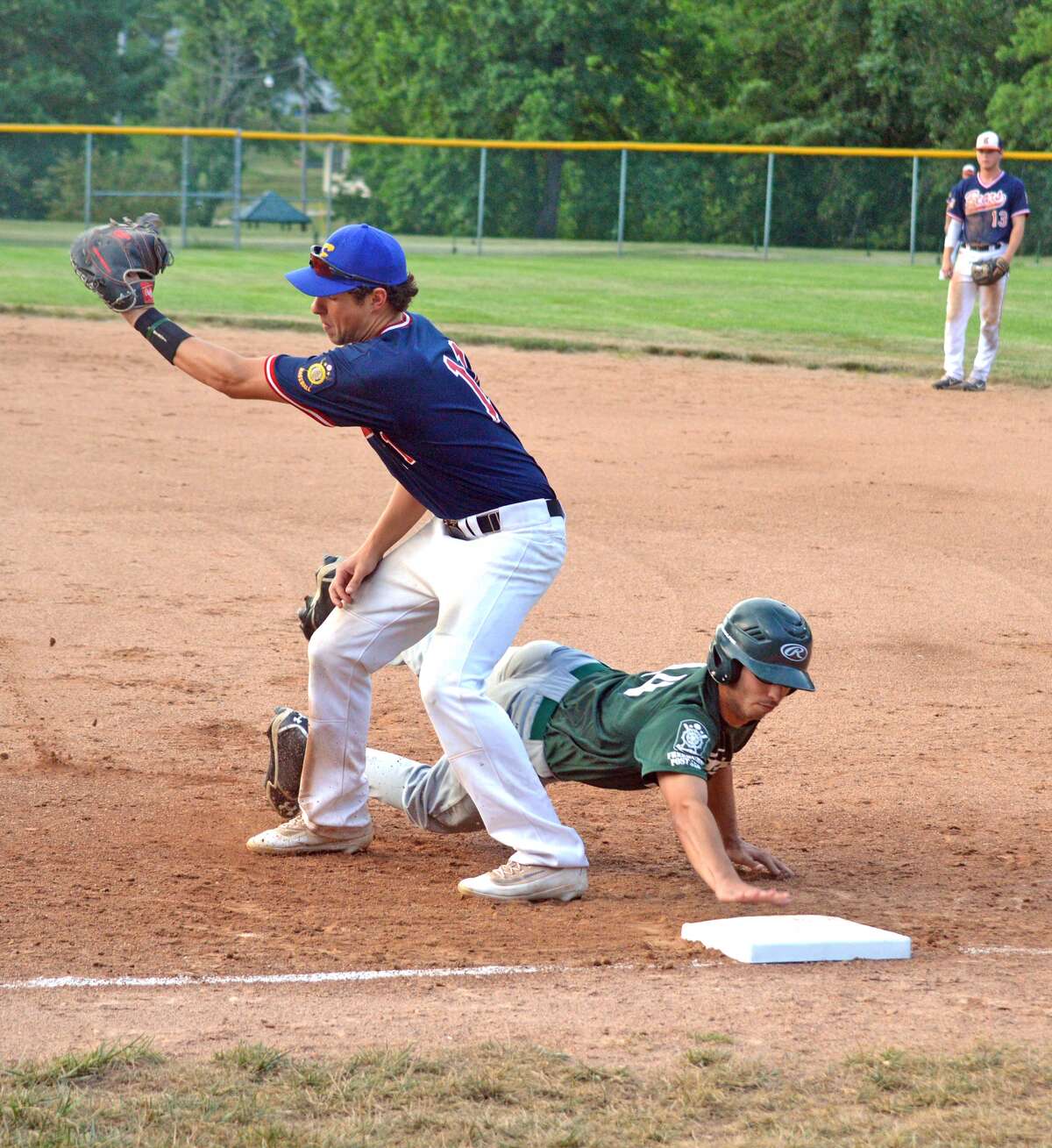 Bears first baseman Cole Hansel, left, takes a throw on an attempted pickoff in the second inning.