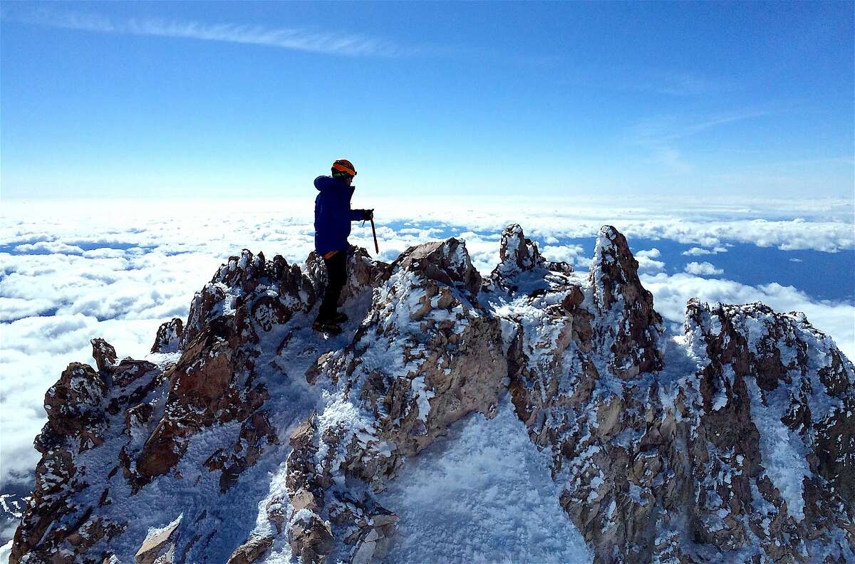 Ryan Ghelfi on the 14,179-foot summit of Mount Shasta in Northern California. The summit is a lava plug dome crag. The climb is 7-miles one-way with a climb of 7,000 feet, one of America's greatest mountain climbs that most in good fitness can attempt.