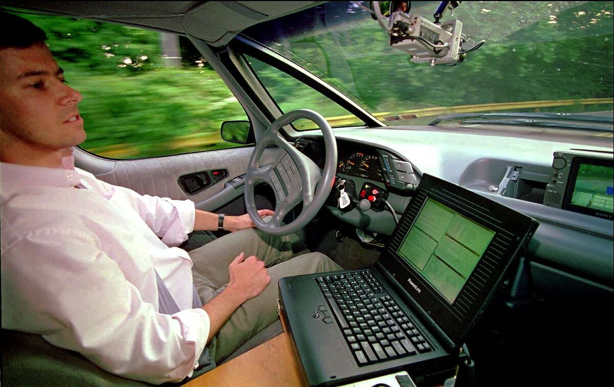 The landscape rushes by as Carnegie Mellon University Robotics Institute scientist Dean Pomerleau demonstrates "hands free" driving through Pittsburgh's Schenley Park near the school's campus on June 12, 1995.