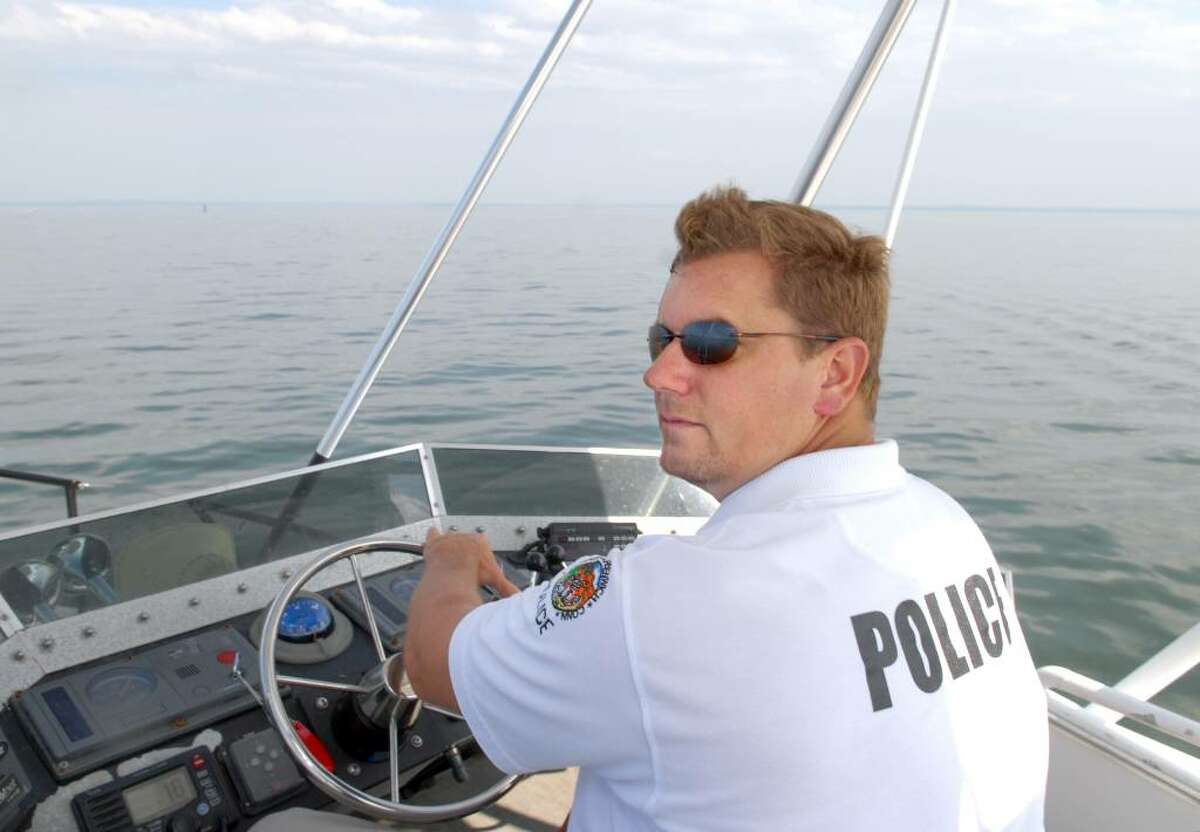 Greenwich Police Marine Officer Josh Rebik pilots the 37-foot police boat #124, as he and fellow Marine Police Officer Tom Etense patrol Long Island Sound off the coast of Greenwich, Thursday afternoon, June 10, 2010.