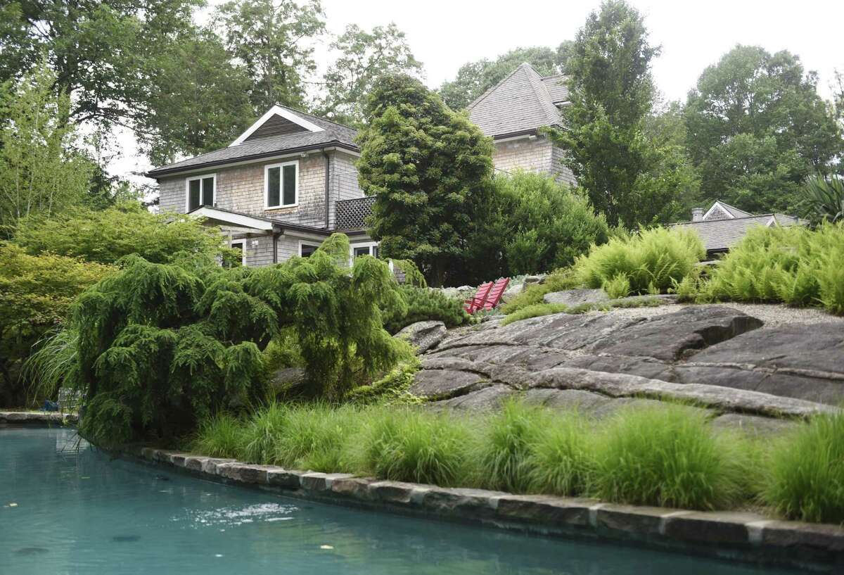 Rocks lead down to a pool in the backyard of Mary Hardy's home on Cognewaugh Road in the Cos Cob section of Greenwich, Conn. Tuesday, July 11, 2017. The 5 bedroom, 5 1/2 bathroom home has characteristics mimicing its owners, including many unique flower arrangements and artifacts from world travels. The 2-acre property features a tree house, teepee and large garden with rocks leading to a poo built into the landscape of the yard.