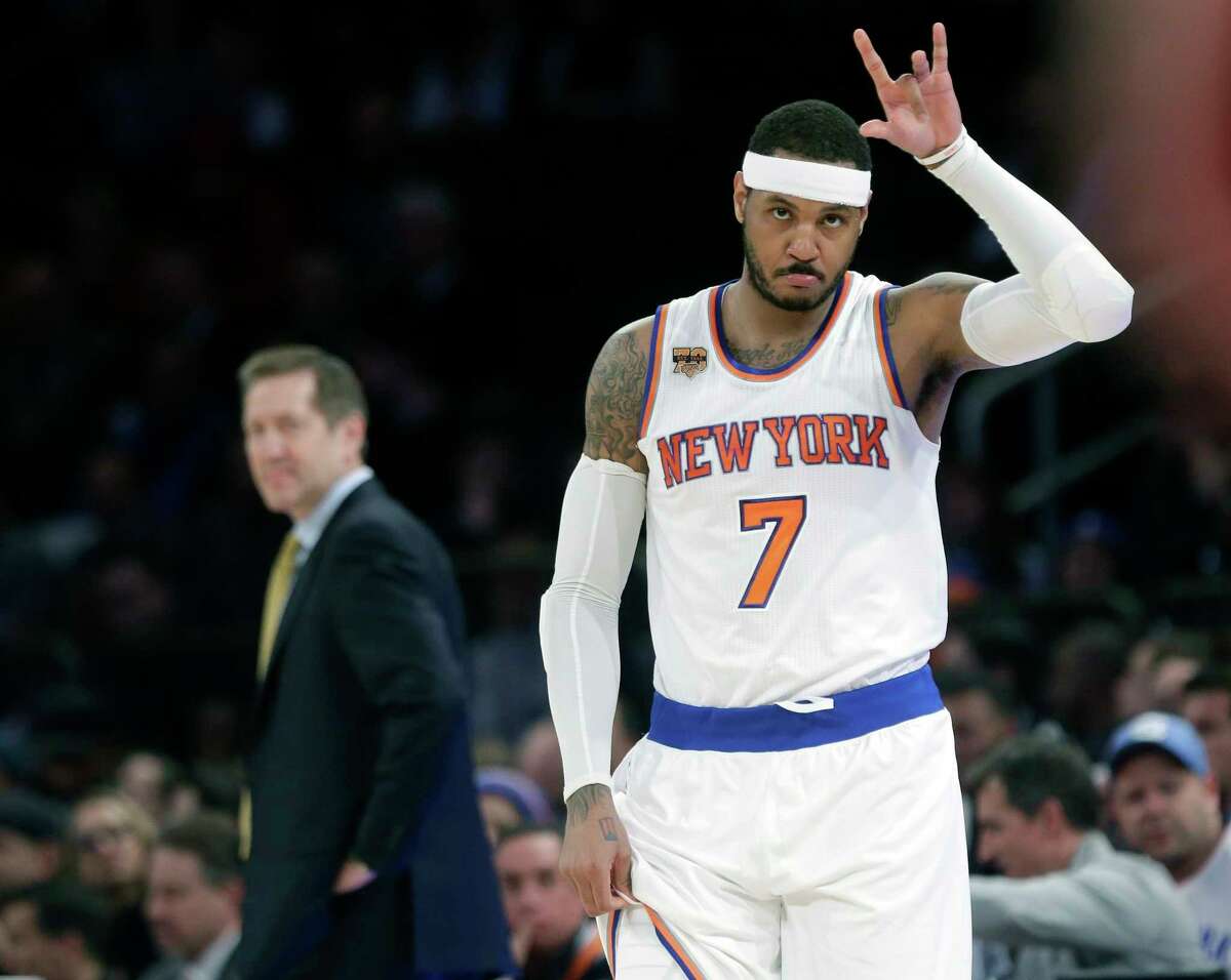 FILE - In this April 4, 2017, file photo, New York Knicks' Carmelo Anthony (7) checks in as coach Jeff Hornacek, left, watches during the first half of an NBA basketball game against the Chicago Bulls, in New York. The New York Knicks and Houston Rockets continue talking about a trade for Carmelo Anthony, though a person with knowledge of the details says no deal is imminent. Anthony has told the Knicks he would accept a move to the Rockets but the teams are still trying to find a trade that works for both sides, the person told The Associated Press on Thursday, July 13, 2017. (AP Photo/Frank Franklin II, File)