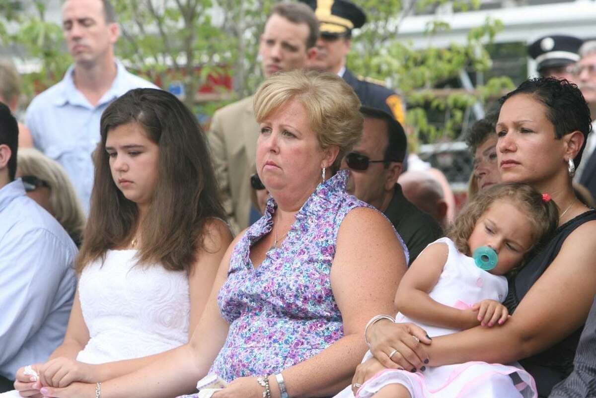 Family members, from left, Margaret Baik, Laurie Baik, Marianne Velasquez, and Salina Velasquez, attend a Bridgeport Fire Department Memorial Dedication ceremony honoring firefighter Michel Baik and Lt. Steven Velasquez on Sunday, July 24, 2011. The firefighters were killed in the line of duty last year. The ceremony took place at the Engine 7/ Ladder 11 firehouse on Ocean Terrace.