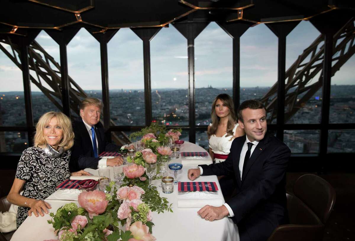 President Donald Trump, first lady Melania Trump, French President Emmanuel Macron his wife Brigitte Macron, are photographed as they sit for dinner at the Jules Verne Restaurant on the Eiffel Tower in Paris, Thursday, July 13, 2017. (AP Photo/Carolyn Kaster)