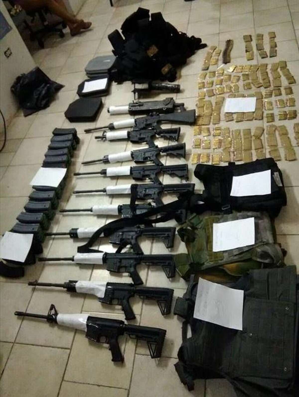 Mexican soldiers said they seized the weapons shown in this picture in Nuevo Laredo. Authorities also arrested five people in connection with the case.